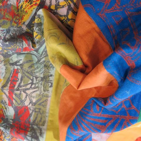 Close up of brightly coloured and patterned fabrics.
