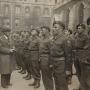 Black and white photo of soldiers of the Oxfordshire & Buckinghamshire Light Infantry standing to attention while gathered in Oxford. They are being inspected by Major John Howard and the Mayor of Oxford during a parade in May 1944